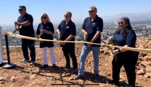 The JCSD Board starting to cut the ribbon to welcome JCSD's first heli-hydrant into operation.