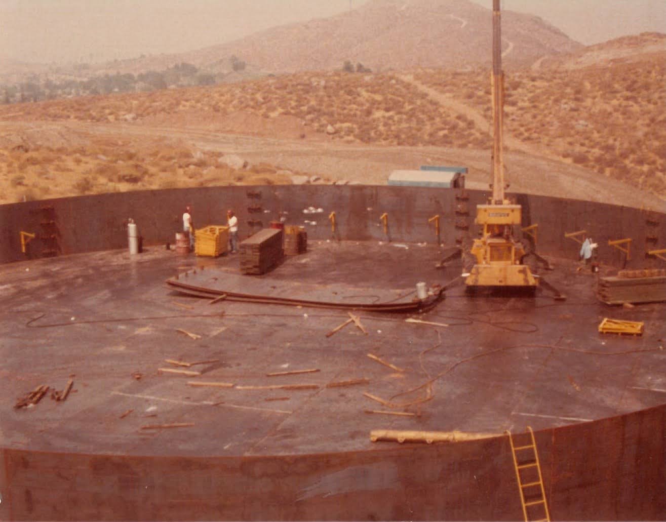 1970s Reservoir Construction Construction Equipment inside water reservoir construction site.